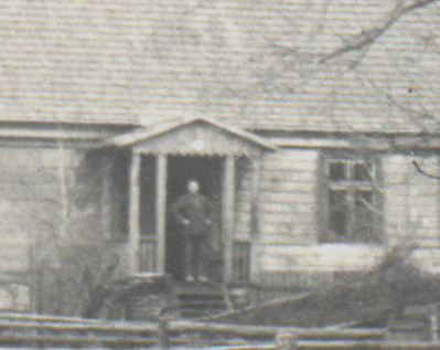 Person in door of Digaini farm 1927