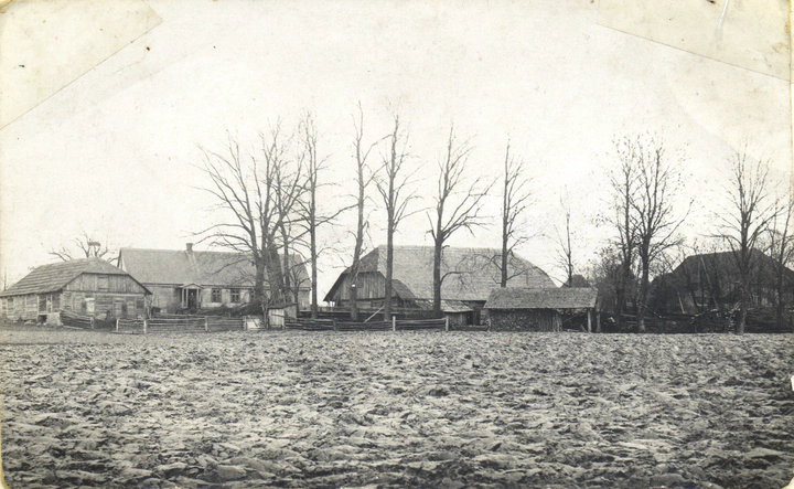 Digiani farm buildings with plowed field in foreground