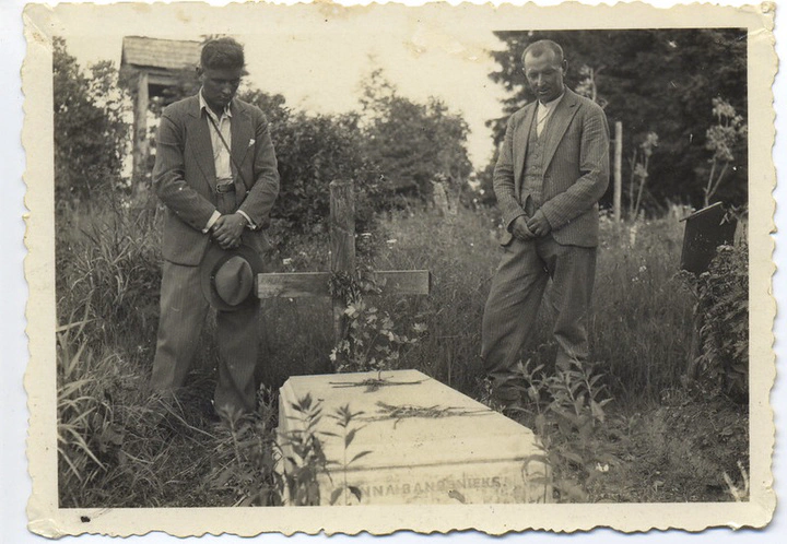 two men next to a coffin